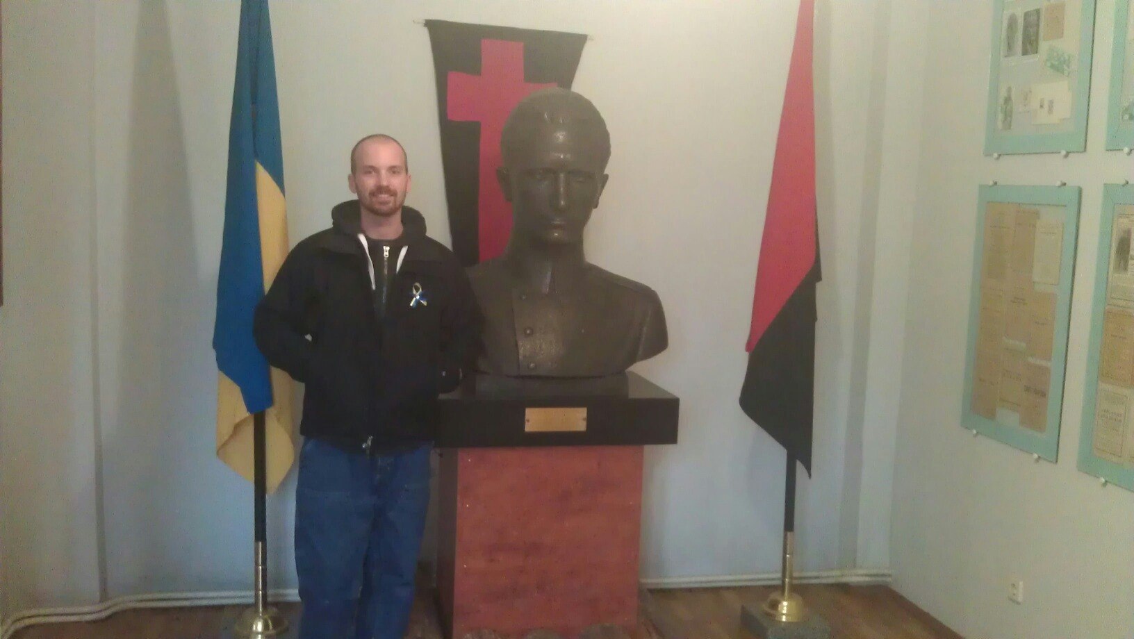 Frank Bagley pictured with a bust of Roman Shukhevych at a museum in Lviv.