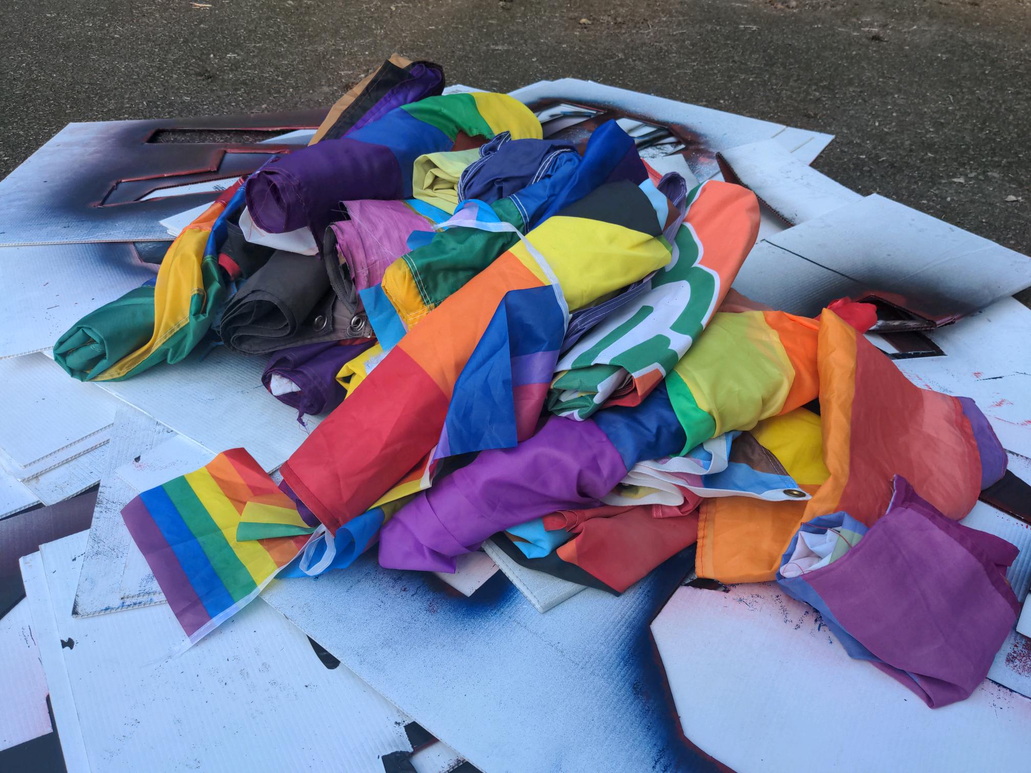These pride flags are from Bagley's shed and match images Bagley himself posted in private neo-Nazi Telegram channels after the theft. Underneath the flags are large Patriot Front stencils that were also stored in the shed.