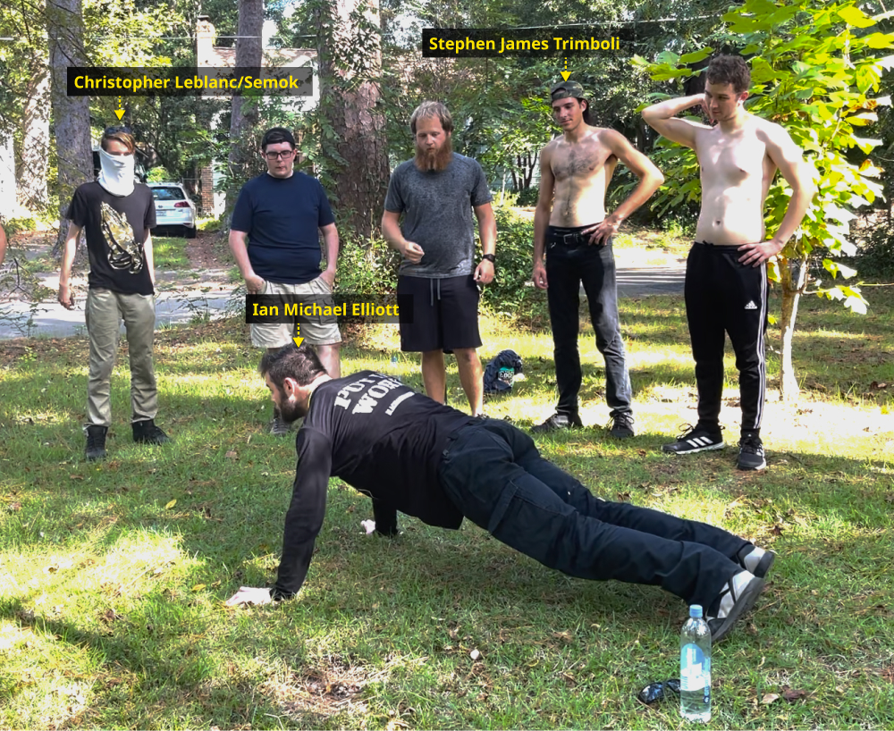 Ian Michael Elliott instructs Patriot Front members on how to do a proper push-up in preparation for a fitness standards assessment. Several of the members fail the assessment.